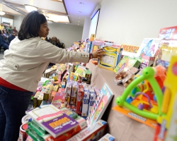Demetria Hereford, ASsistant Director of the McNair Program, helps set out toys to be given away to university service employees at the annual Books and Bears distribution.  Photo by Nathan Latil/Ole Miss Communications