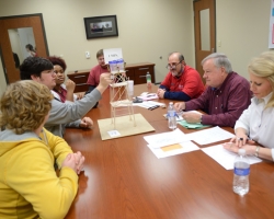 Olive Branch H.S. students Lee Ward, Alex Drew and Kayla Toney explain their water tower design, made to withstand simulated earthquake effects, to the judges at the 2013 Engineering Day Competition. Photo by Nathan Latil/Ole Miss Communications