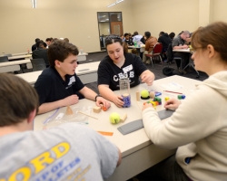 Oxford High students Connor Vinson, Rachel Sahlein, and Tiffany Torma (l-r) participate in the team activity portion of the 2013 Engineering Day Competition.  Photo by Nathan Latil/Ole Miss Communications