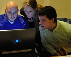 University of Mississippi students Andrew Henning (left), Kristen Vise and Mitchell Hobbs look at some of the first images rendered of the 'Archaionomia' over spring break at the Folger Shakespeare Library. UM photo by Robert Jordan.