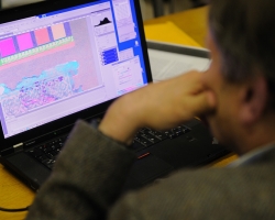 Roger L. Easton Jr., professor at the Center for Imaging Science at the Rochester Institute of Technology, processes the first of the multispectral images created of the 'Archaionomia' to enhance the signature's visibility. UM photo by Robert Jordan.
