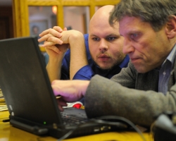 University of Mississippi student Andrew Henning (left) looks on as Roger L. Easton Jr., professor at the Center for Imaging Science at the Rochester Institute of Technology, processes a multispectral image created of the 'Archaionomia' to enhance the signature's visibility. UM photo by Robert Jordan.