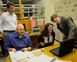 University of Mississippi professor Gregory Heyworth (left), UM student Andrew Henning and Renate Mesmer, head of conservation at the Folger Shakespeare Library,  review the first of the multispectral images of the 'Archaionomia' signature that have been processed to enhance their visibility by Roger L. Easton Jr. (standing far right), professor at the Center for Imaging Science at the Rochester Institute of Technology. UM photo by Robert Jordan.