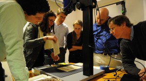 Renate Mesmer (second from left), head of conservation at the Folger Shakespeare Library, repositions the 'Archaionomia' under the imaging camera as (left to right) Mitchell Hobbs, Gregory Heyworth, Kristen Vise and Andrew Henning, all of the University of Mississippi, and William A. Christens-Barry, chief scientist with Equipoise Imaging, watch. UM photo by Robert Jordan.