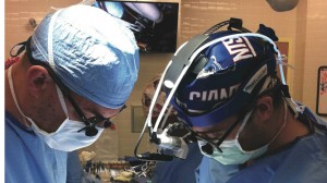 Dr. Jorge Salazar (left) and Dr. Daniel DiBardino perform surgery at the UM Medical Center.
