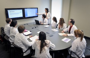 Students work on a case during a problem-based learning session in the new School of Pharmacy building in Jackson. The school's students posted a perfect pass rate last year on the North American Pharmacist Licensure Examination. Photo by Jay Ferchaud.