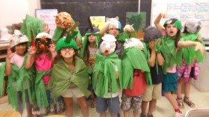 Children show off art projects they made at the museum.