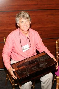 Chuck Jenkins holds a box he won in an auction at an Engineer without Borders banquet. The box contains items from their last trip to Togo, West Africa.