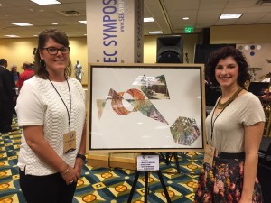 Hailey Hodge (right) stands by her piece "Fragmented House" with her professor, Brooke White. 