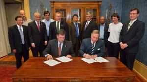 UM Acting Chancellor Morris Stocks (seated, left) and Belhaven University President Roger Parrott sign a dual degree program agreement between the two institutions. UM staff and faculty observing the proceedings were (standing, from left) Noel Wilkin, acting provost; Jacob Najjar, chair of civil engineering; Dwight Waddell, associate professor of electrical engineering; John O’Haver, chair and professor of chemical engineering; James Chambers, associate professor of mechanical engineering; Alex Cheng, engineering school dean; A.M. Rajendran, chair and professor of mechanical engineering; Maurice Eftink, associate provost; and Ellen Lackey, professor of mechanical engineering. Dennis Watts, BU associate provost; (far right) was also present. (Photo by Robert Jordan, UM Imaging Services)