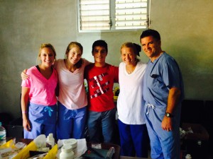The School of pharmacy team poses for a photo with Copan resident Antony (center).
