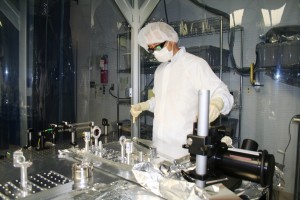 A LIGO team member inspecting the detector portion of the technology inside the laboratory.