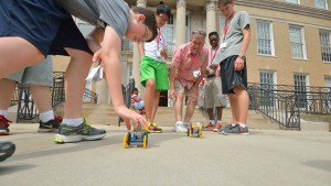 Jim Chambers helps high school students race their solar-powered cars during an engineering camp that he helped launch. Photo by Kevin Bain/Ole Miss Communications
