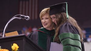 Dr. LouAnn Woodward, vice chancellor for health affairs and dean of the School of Medicine, presents the Waller S. Leathers Award for the medical student with the highest academic average for four years to Amanda Daggett of Jackson.