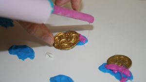 Dr. Nancy Wicker working with the polyvinyl siloxane (PVS) to make impressions from broken portions of bracteates.