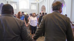 UM community members joined hands in moment of prayer and reflection during the ceremony. Photo by Thomas Graning/Ole Miss Communications