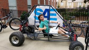 A young visitor to campus tests a SAE project on display. (Submitted photo)